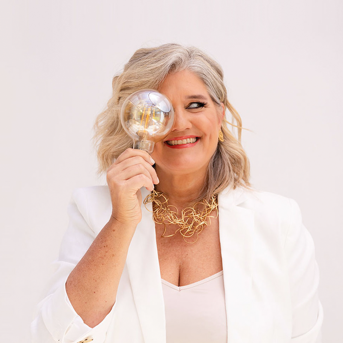 Dolores Hirschmann holding a lightbulb, symbolising clarity