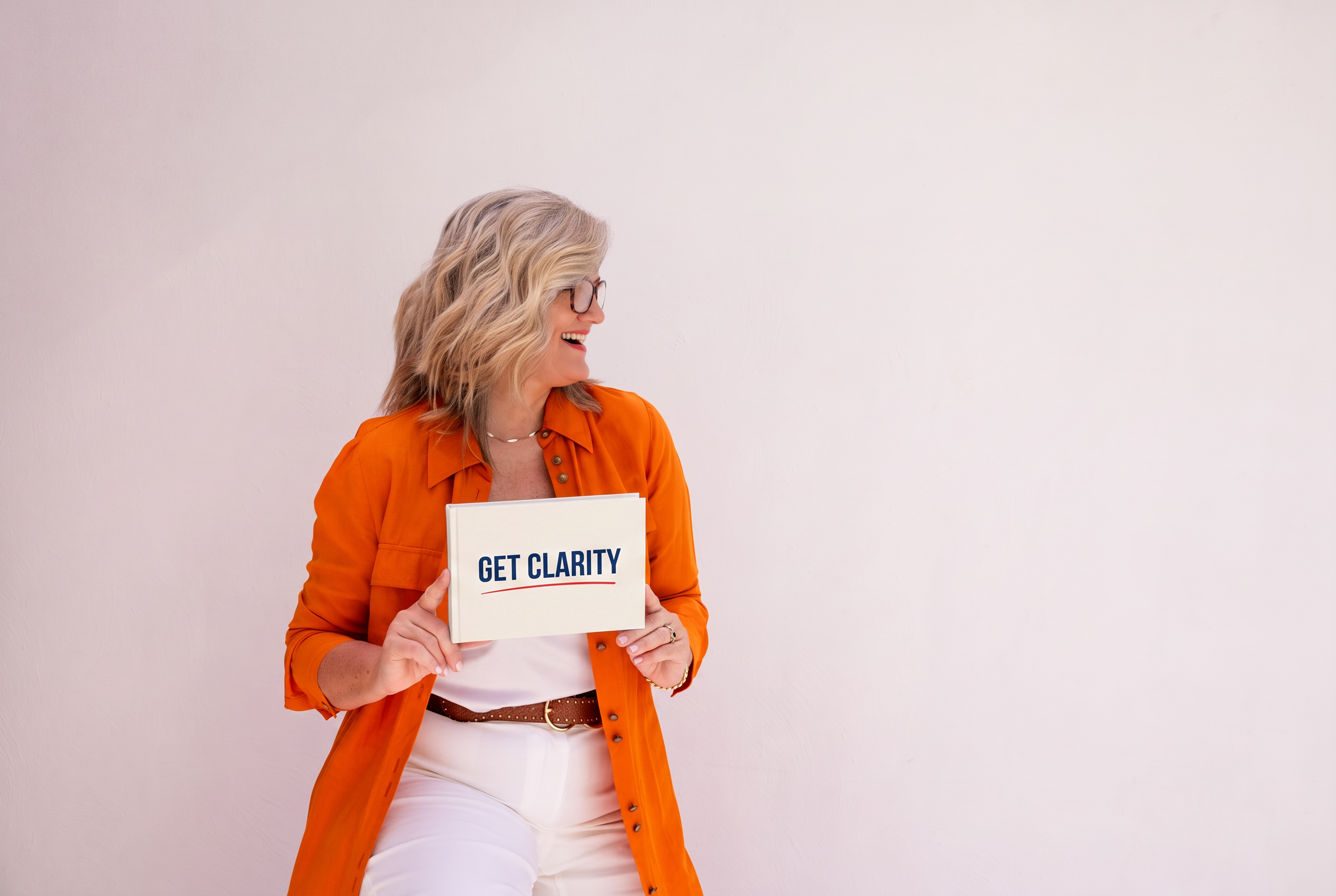 Dolores Hirschmann holding a book that reads Get Clarity